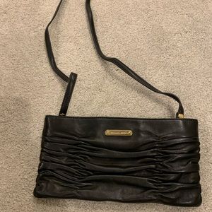Michael Kors black leather clutch purse with optional shoulder strap.